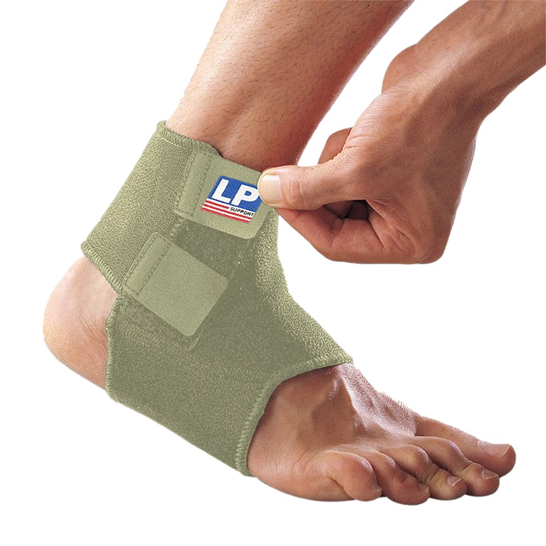 Green ankle support brace being worn on a foot with a visible brand logo.