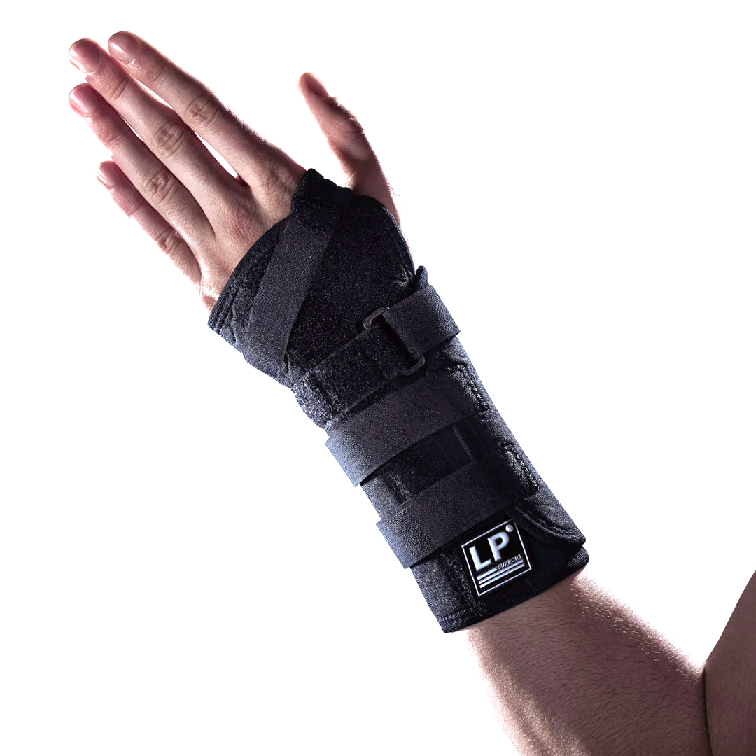 A person's forearm wearing a black LP Support Extreme Wrist/Forearm Brace with Velcro straps and cushion pads.