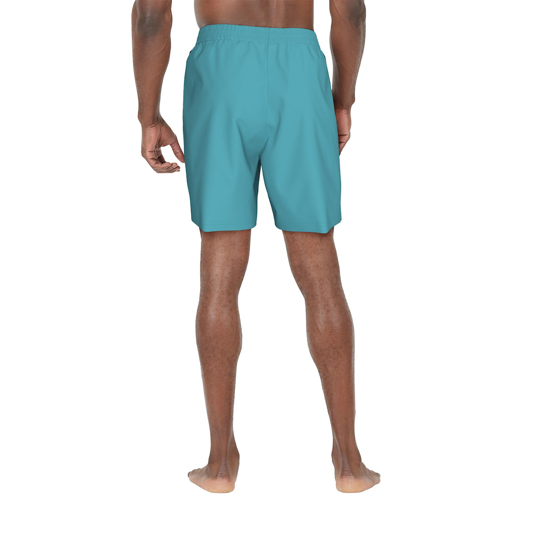 Person wearing teal swim shorts on a white background