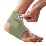 Green ankle support brace being worn on a foot with a visible brand logo.