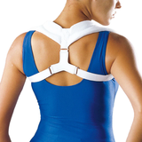 Person wearing a white posture corrector over a blue top on a white background