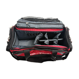 Open red and black duffel bag with compartments on a white background