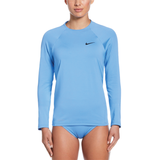 Woman wearing a blue long-sleeve athletic top with a Nike logo on a white background