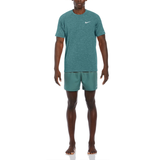 Man wearing a green Nike outfit on a white background