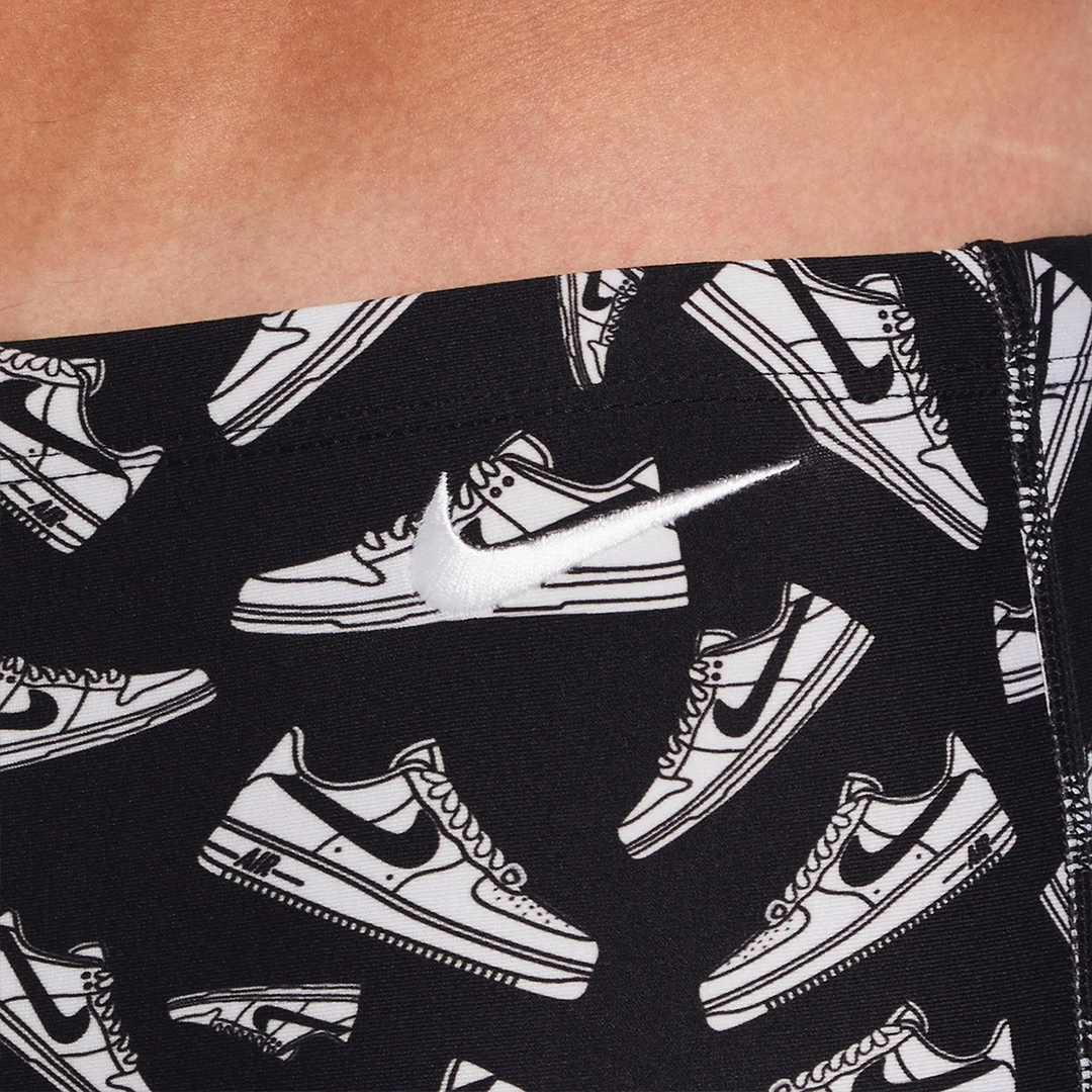 Black leggings with white sneaker pattern on a person wearing them.