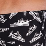 Black leggings with white sneaker pattern on a person wearing them.