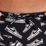 Black swim shorts with white sneaker pattern and Nike branding.