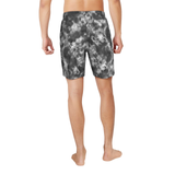Person wearing gray tie-dye shorts on a white background
