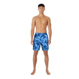 Man wearing blue tie-dye swim shorts on a white background