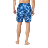 Blue tie-dye shorts worn by a person on a white background