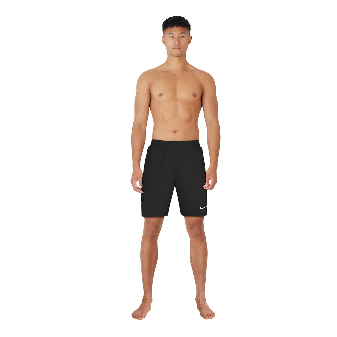 Man wearing black Nike swim shorts on a white background