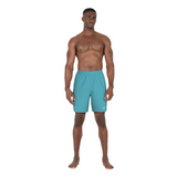 Man wearing teal swim shorts on a white background