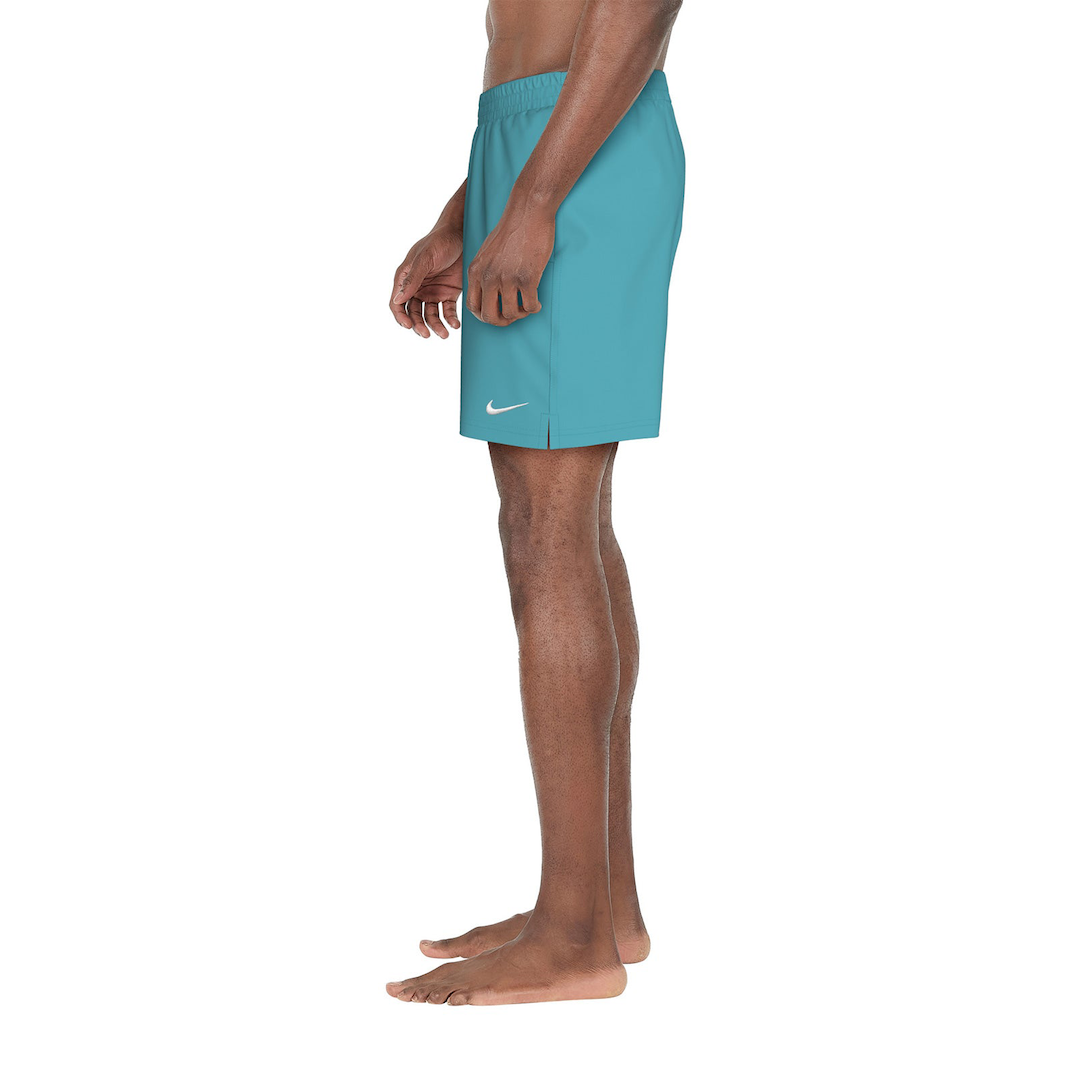 Teal Nike shorts worn by a person on a white background