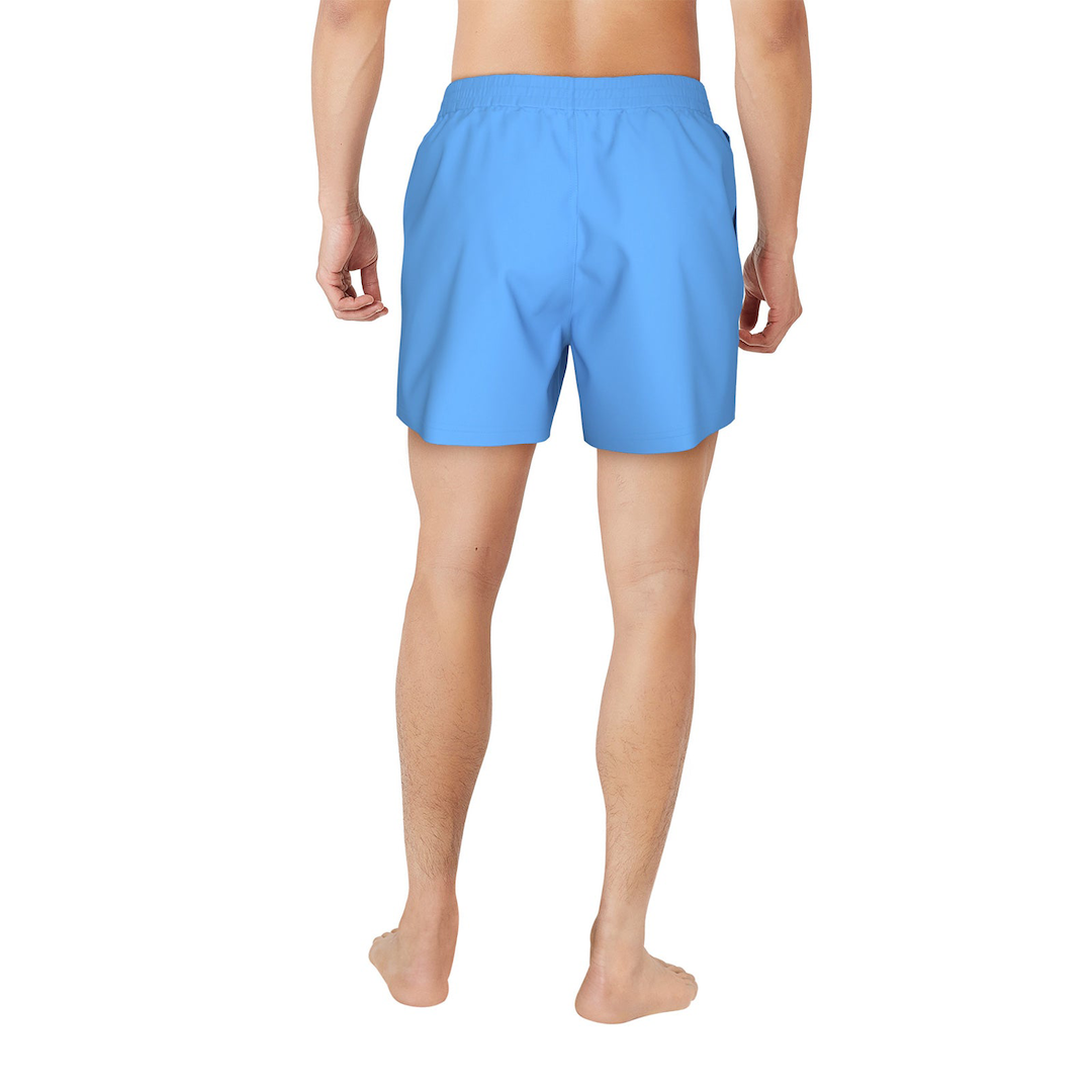 Person wearing blue swim shorts on a white background