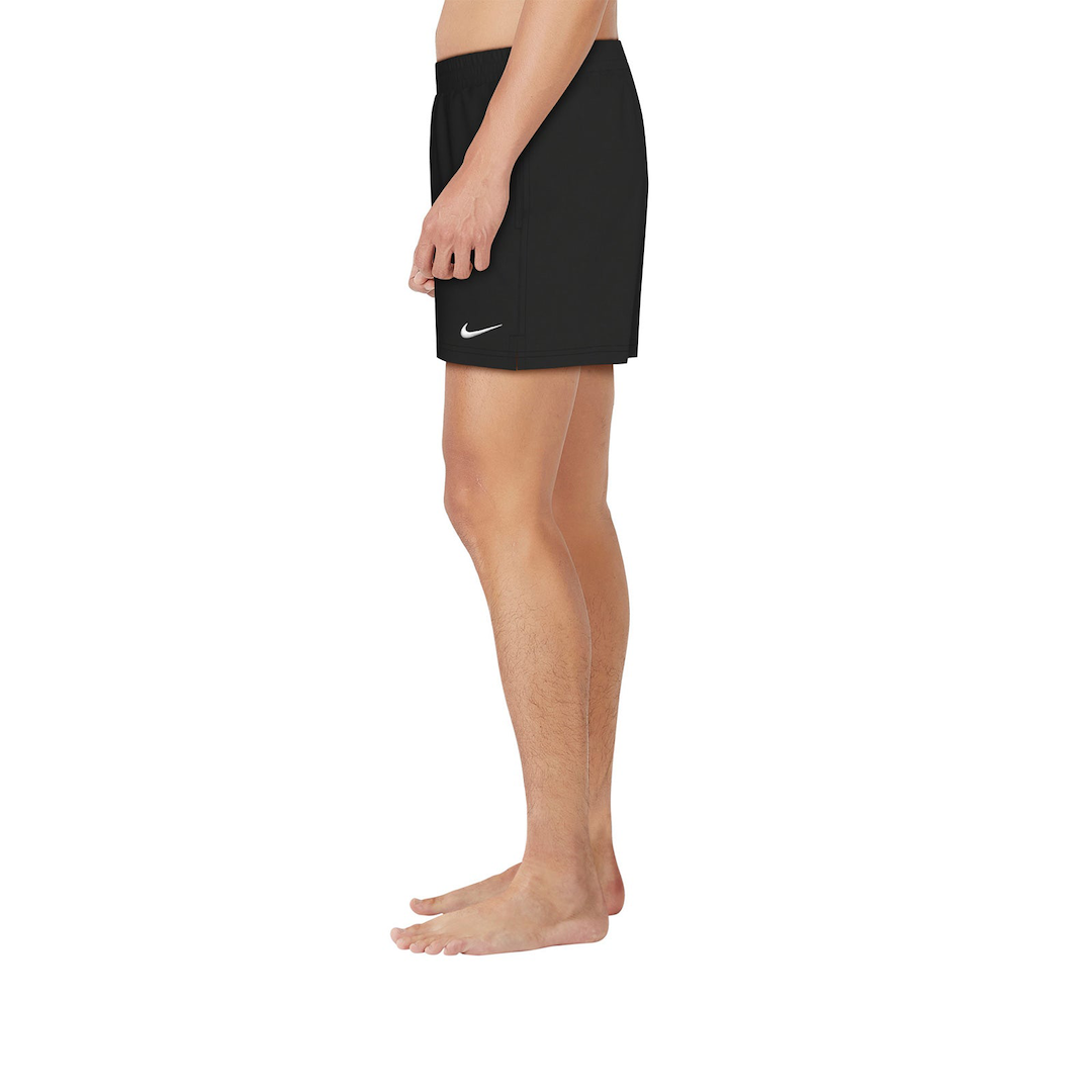 Person wearing a black Nike skirt on a white background