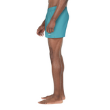Person wearing teal shorts with a Nike logo on a white background