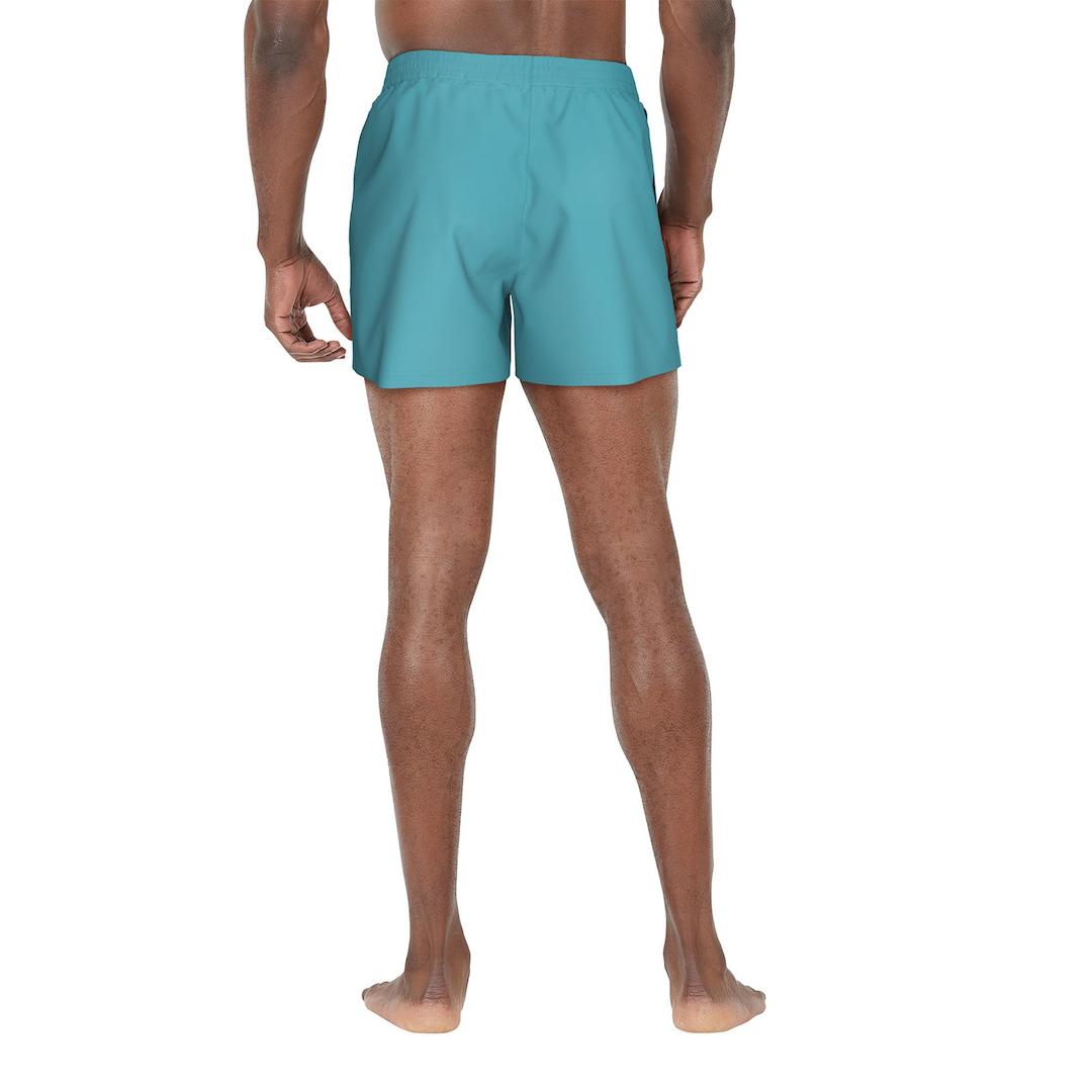 Person wearing teal swim shorts on a white background