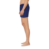 Person wearing navy blue shorts with a brand logo on a white background